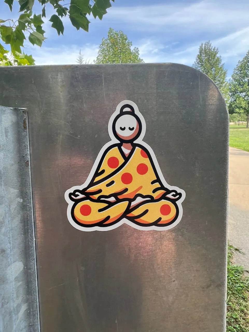 za zen pizza monk sticker slapped on the back of a metal sign